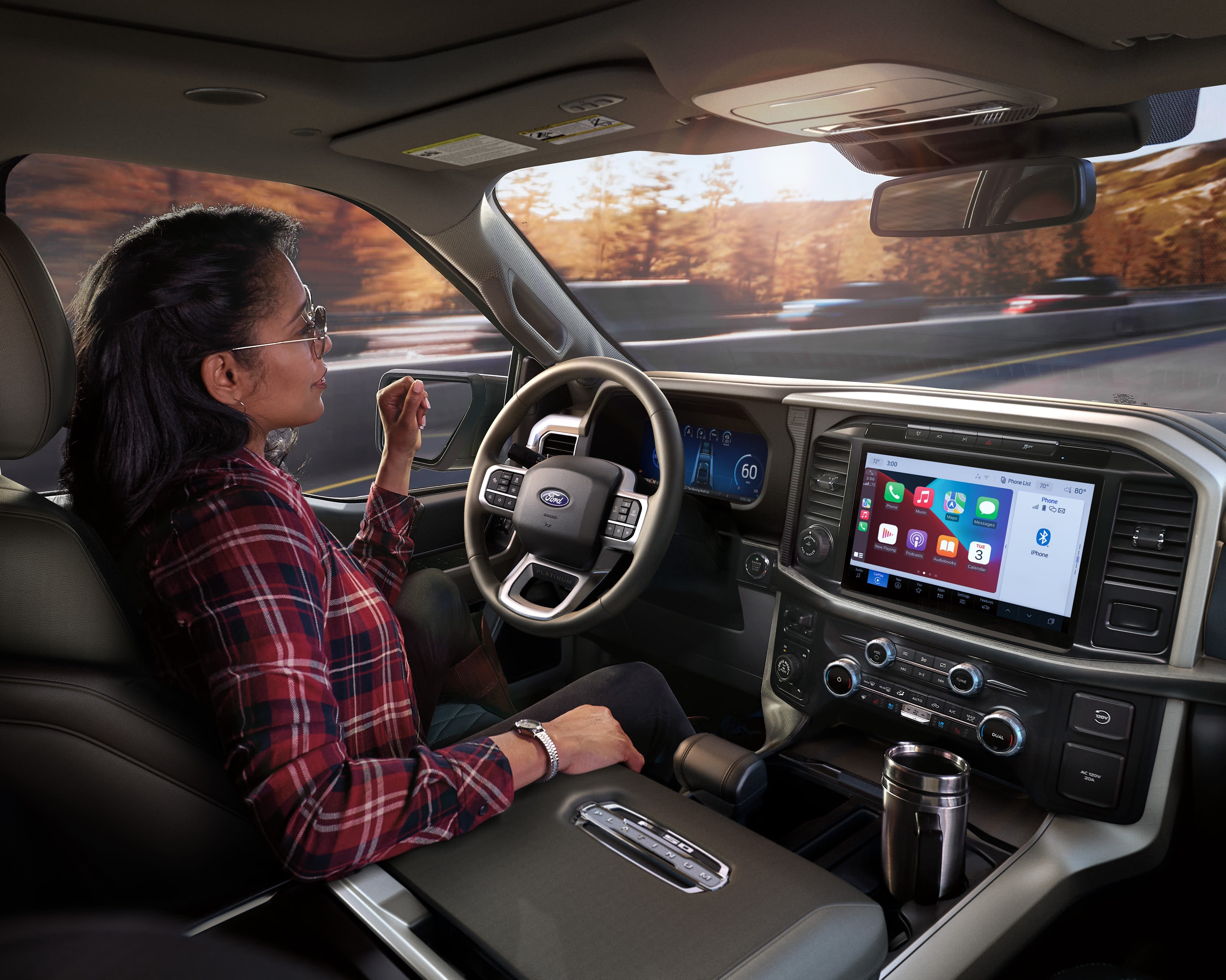 A driver demonstrating Ford BlueCruise handsfree technology on a divided highway